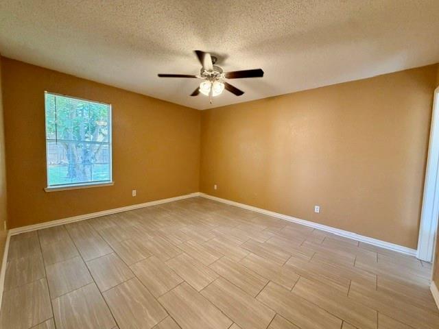 2604 Crix Lane Fort Worth, TX 76140 - Photo 5 of 13 Room featuring light-toned tile flooring, neutral wall paint, and white baseboards