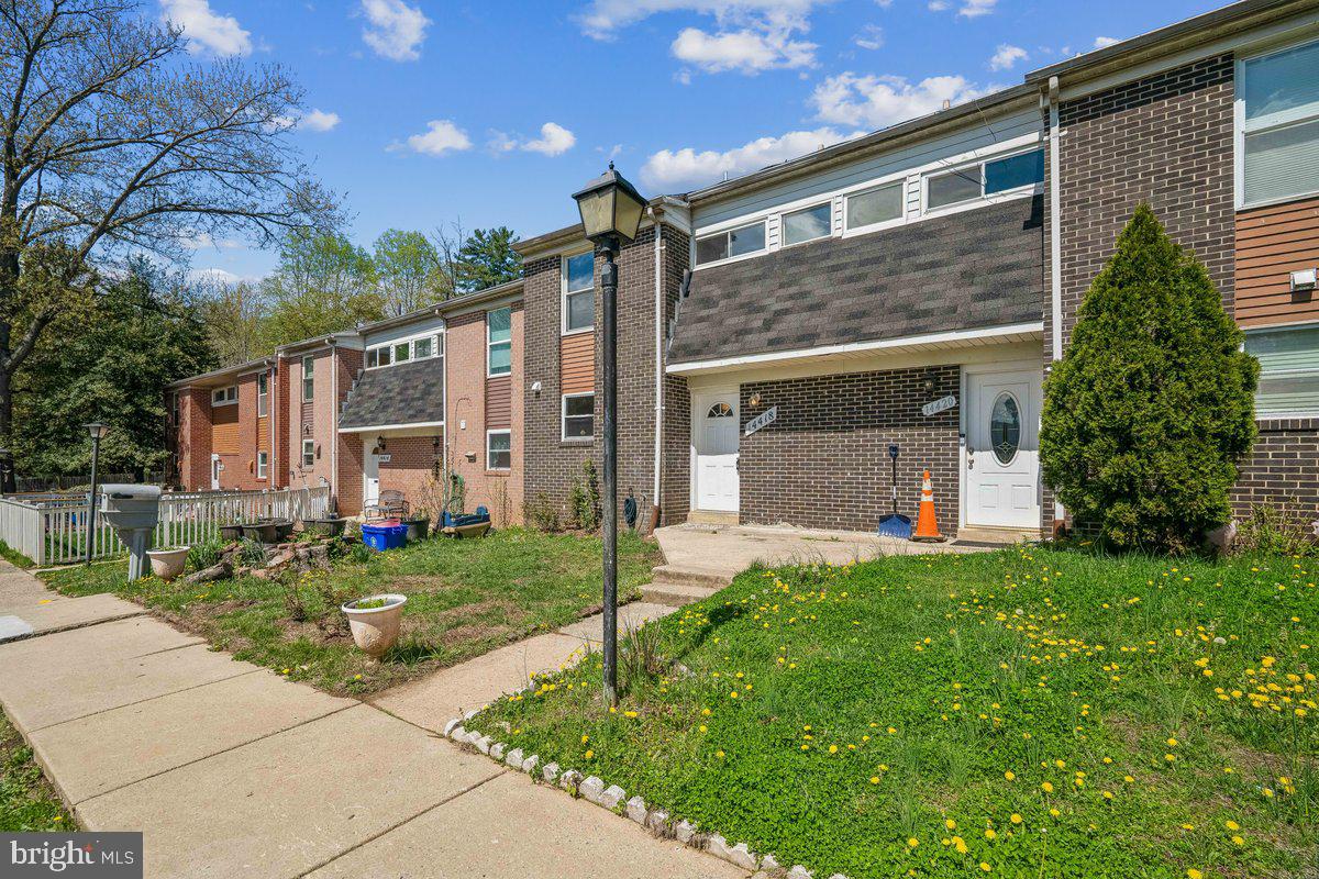 14418 Bel Pre Drive Silver Spring, MD 20906 - Photo 3 of 14 a front view of a house with a yard and garage