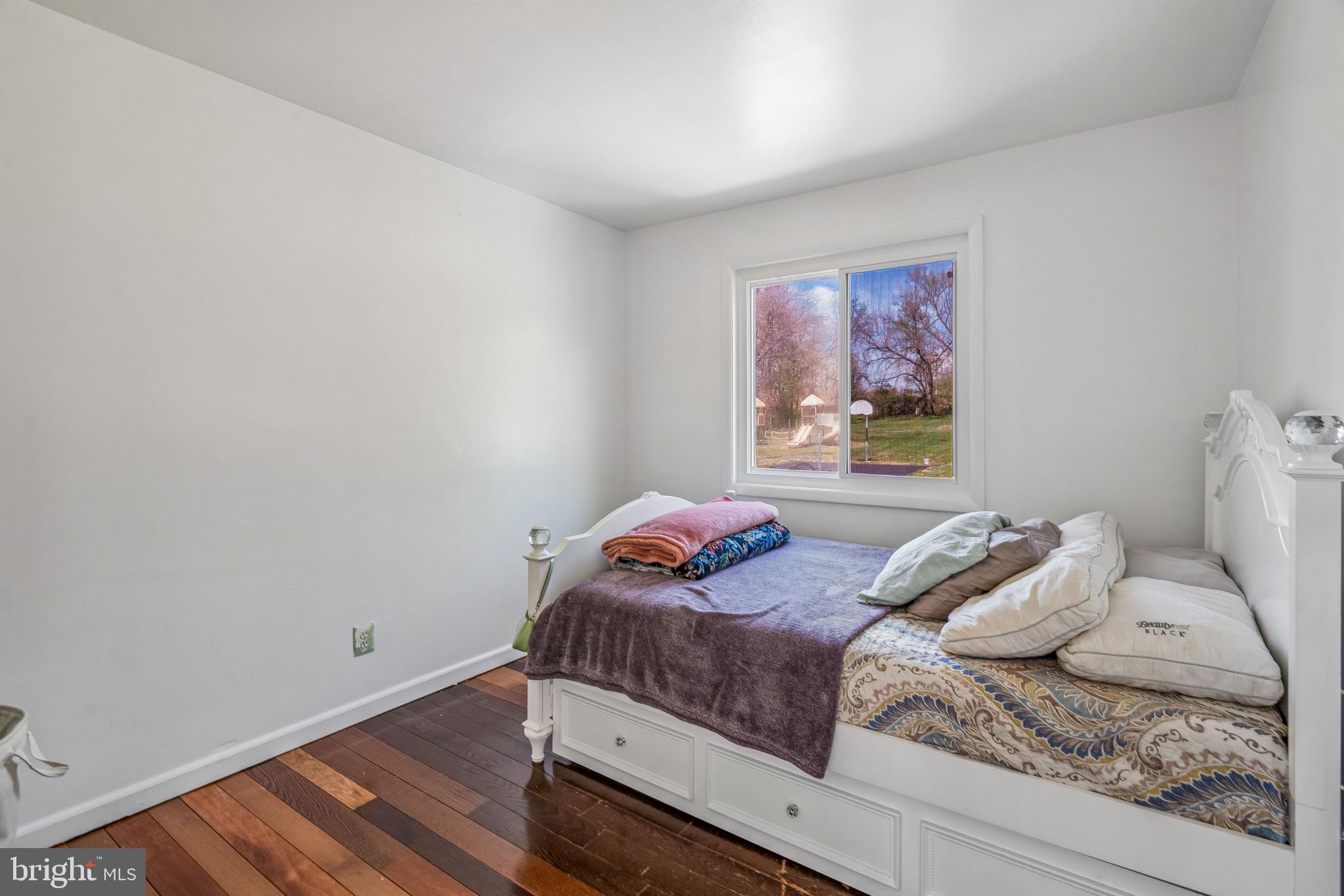14418 Bel Pre Drive Silver Spring, MD 20906 - Photo 10 of 14 a bedroom with a bed and a window