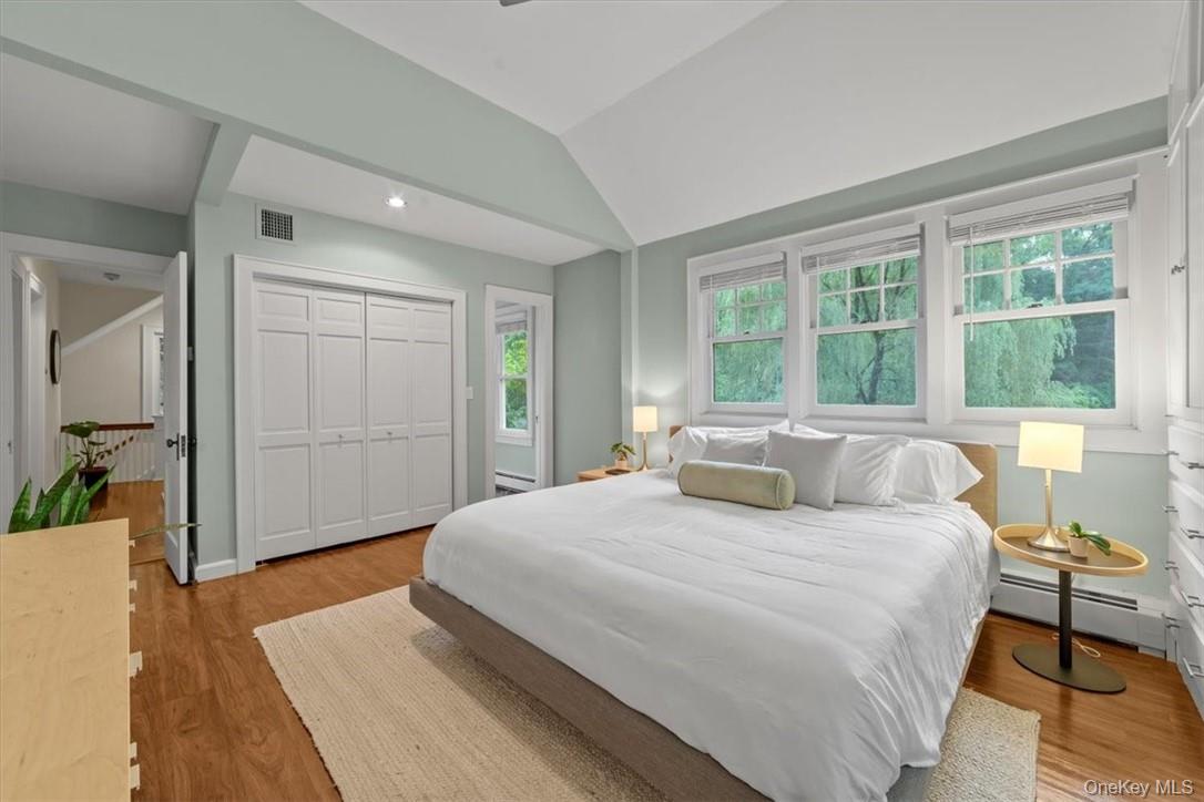 28 Inningwood Road Ossining, NY 10562 - Photo 25 of 37 Bedroom featuring a closet, light hardwood / wood-style flooring, multiple windows, and a baseboard radiator
