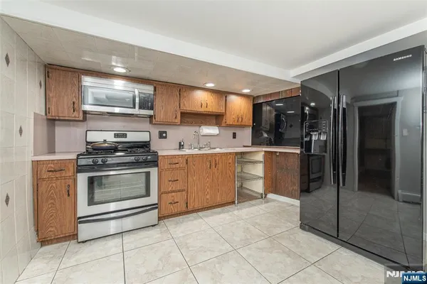 a kitchen with a stove a sink and a refrigerator