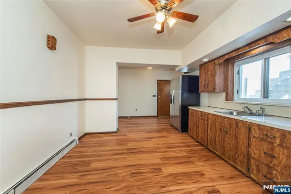 a view of a kitchen with a sink and wooden floor
