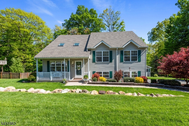 21 Towpath Lane Stanhope, NJ 07874 - Photo 1 of 37 a front view of a house with a yard table and chairs