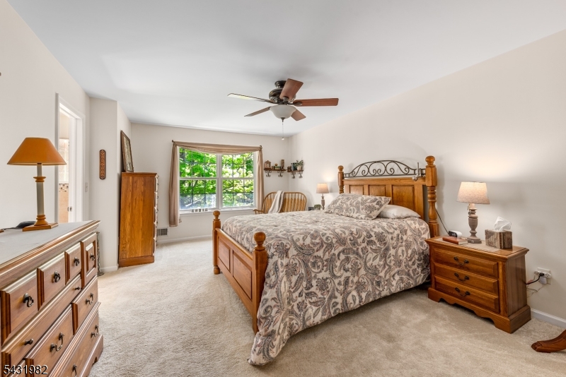 21 Towpath Lane Stanhope, NJ 07874 - Photo 17 of 37 a bedroom with a bed and a chandelier