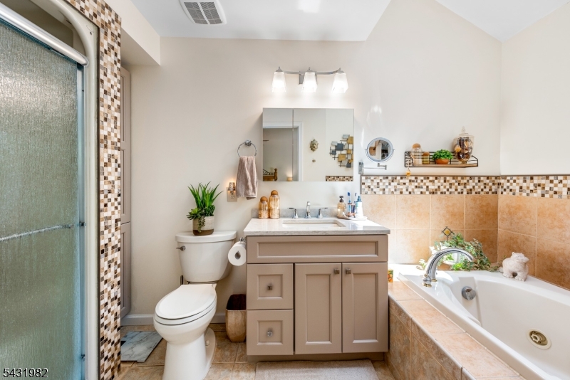 21 Towpath Lane Stanhope, NJ 07874 - Photo 18 of 37 a bathroom with a sink a toilet and tub