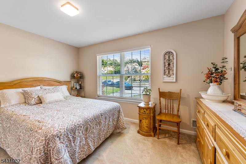 21 Towpath Lane Stanhope, NJ 07874 - Photo 20 of 37 a bedroom with a bed and a chandelier