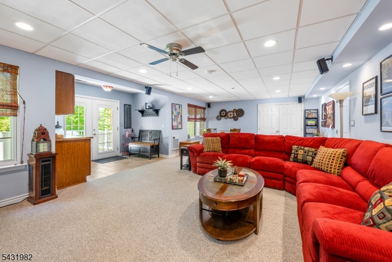 21 Towpath Lane Stanhope, NJ 07874 - Photo 22 of 37 a living room with furniture a fireplace and a chandelier