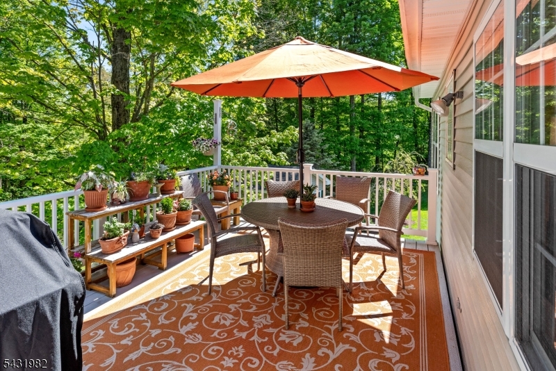 21 Towpath Lane Stanhope, NJ 07874 - Photo 29 of 37 a view of a patio with a table and chairs under an umbrella