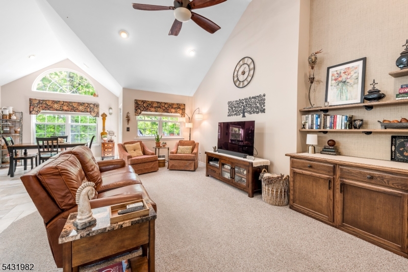 21 Towpath Lane Stanhope, NJ 07874 - Photo 8 of 37 a living room with furniture a flat screen tv and a window