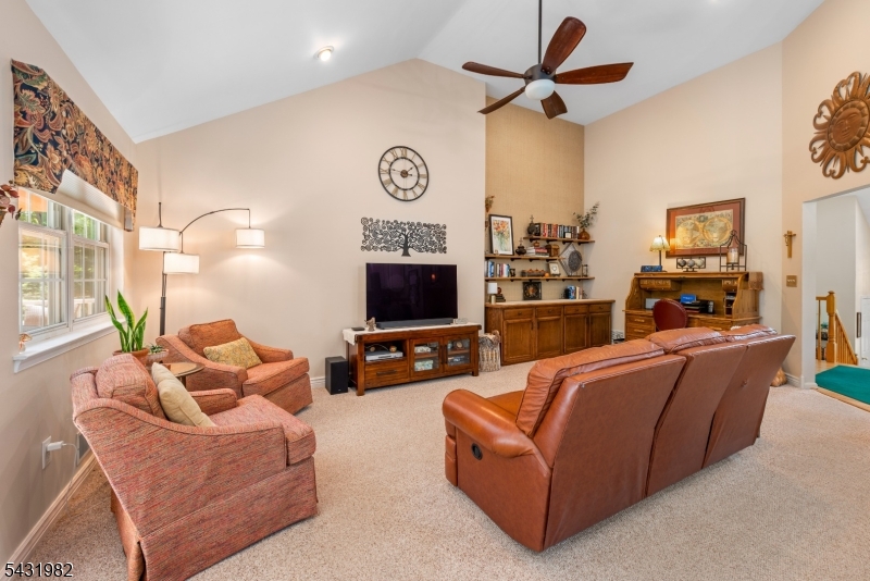21 Towpath Lane Stanhope, NJ 07874 - Photo 10 of 37 a living room with furniture a flat screen tv and a fireplace