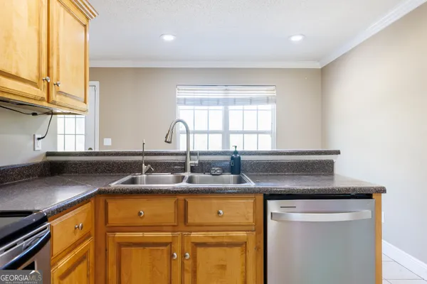 a kitchen with granite countertop cabinets and window