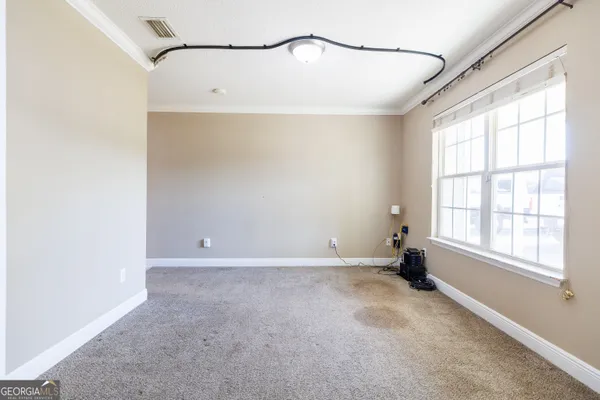 a view of a big room with windows and chandelier fan