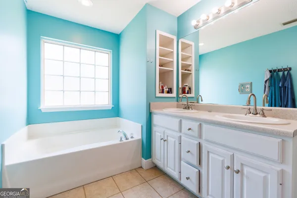 a bathroom with a tub sink and a mirror