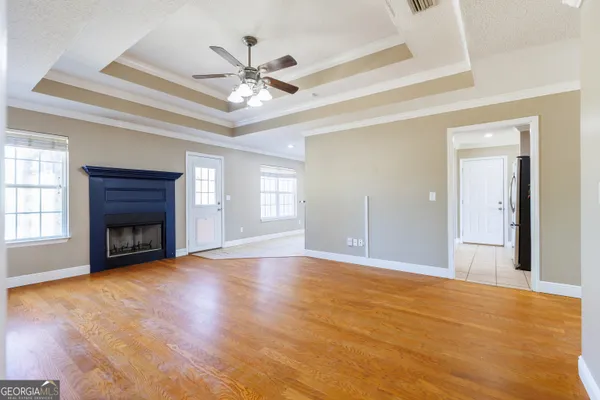 a view of an empty room with a fireplace and a window