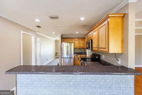 a view of a kitchen with a large window
