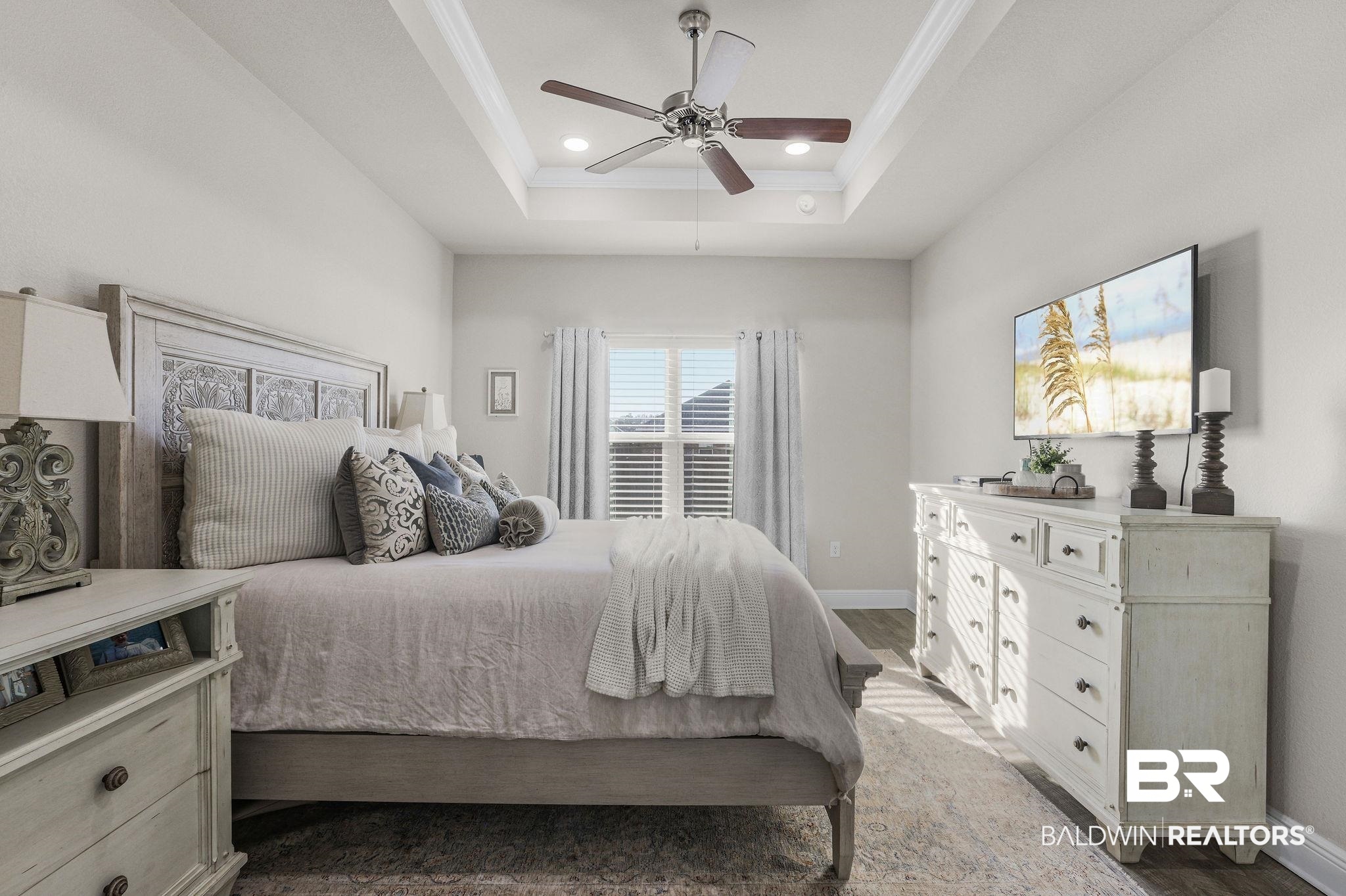 9056 Impala Drive Foley, AL 36535 - Photo 10 of 22 Bedroom with crown molding, ceiling fan, a raised ceiling, and hardwood / wood-style floors