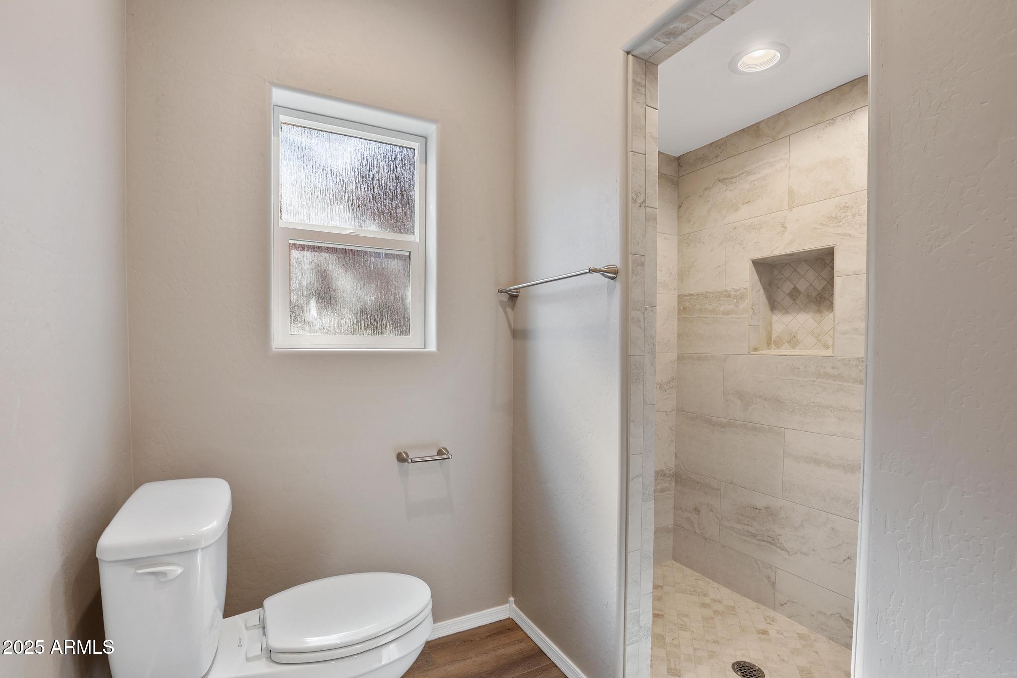 1019 South Ponderosa Street Payson, AZ 85541 - Photo 15 of 34 a white toilet sitting next to a bathroom sink