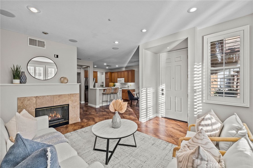 a living room with furniture a window and a fireplace