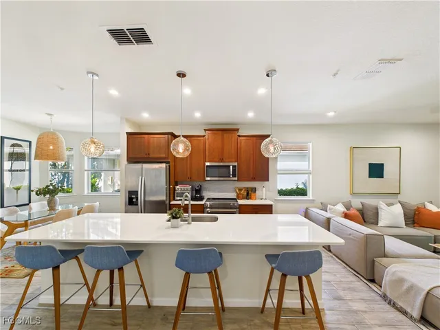 a kitchen with a table chairs stove and a window