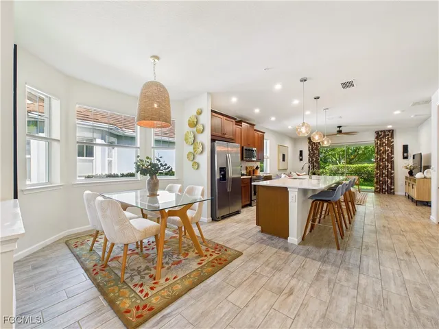 a living room with dining room and kitchen view
