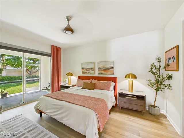 a bedroom with a bed and a potted plant