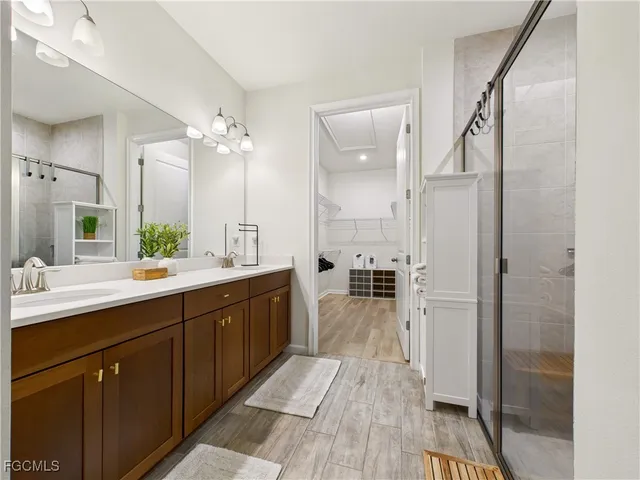 a spacious bathroom with a double vanity sink mirror and shower