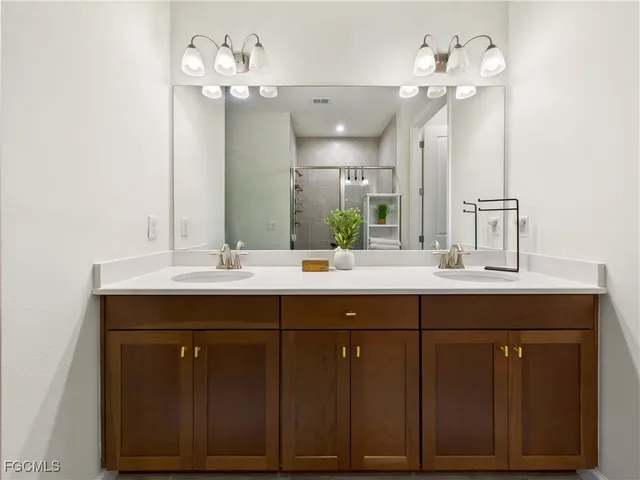 a bathroom with a sink vanity and a mirror