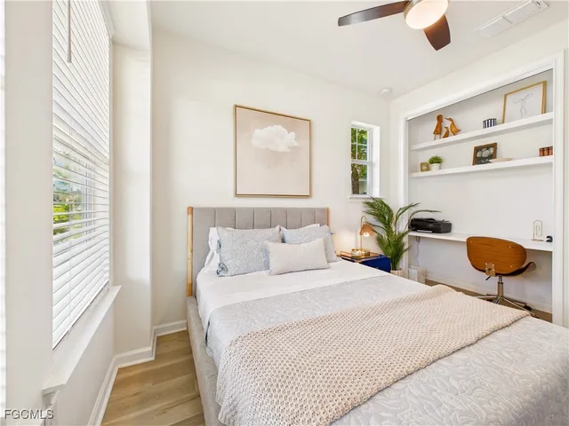 a bedroom with bed and a potted plant