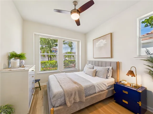 a bedroom with a bed and a large window
