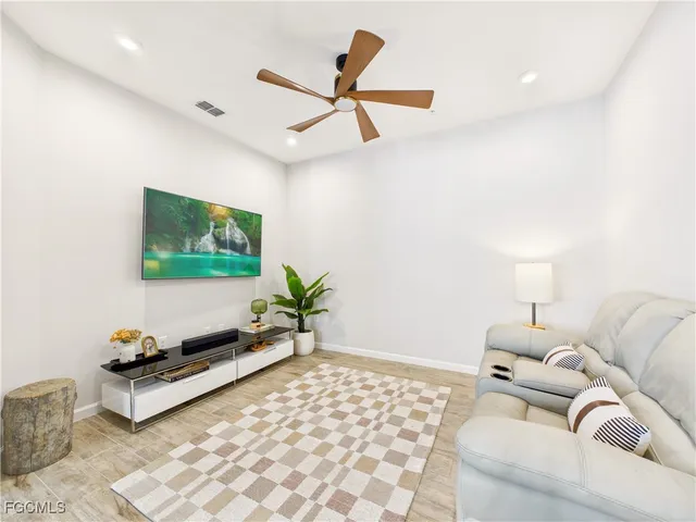 a living room with furniture and a potted plant