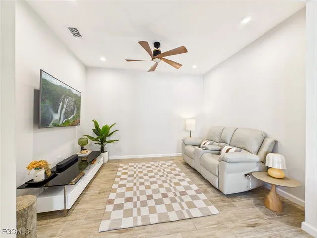a living room with furniture and a potted plant