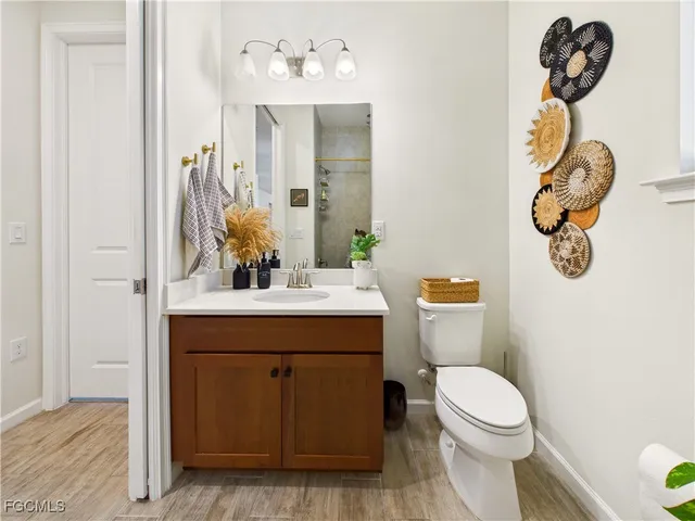 a bathroom with a sink mirror vanity and toilet