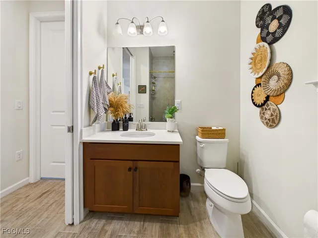 a bathroom with a sink a toilet and mirror