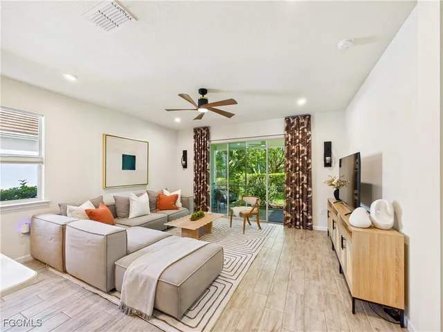 a living room with furniture and a large window