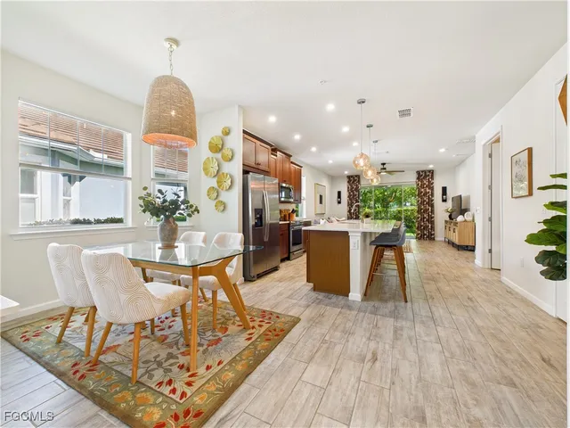 a living room with dining room and wooden floor