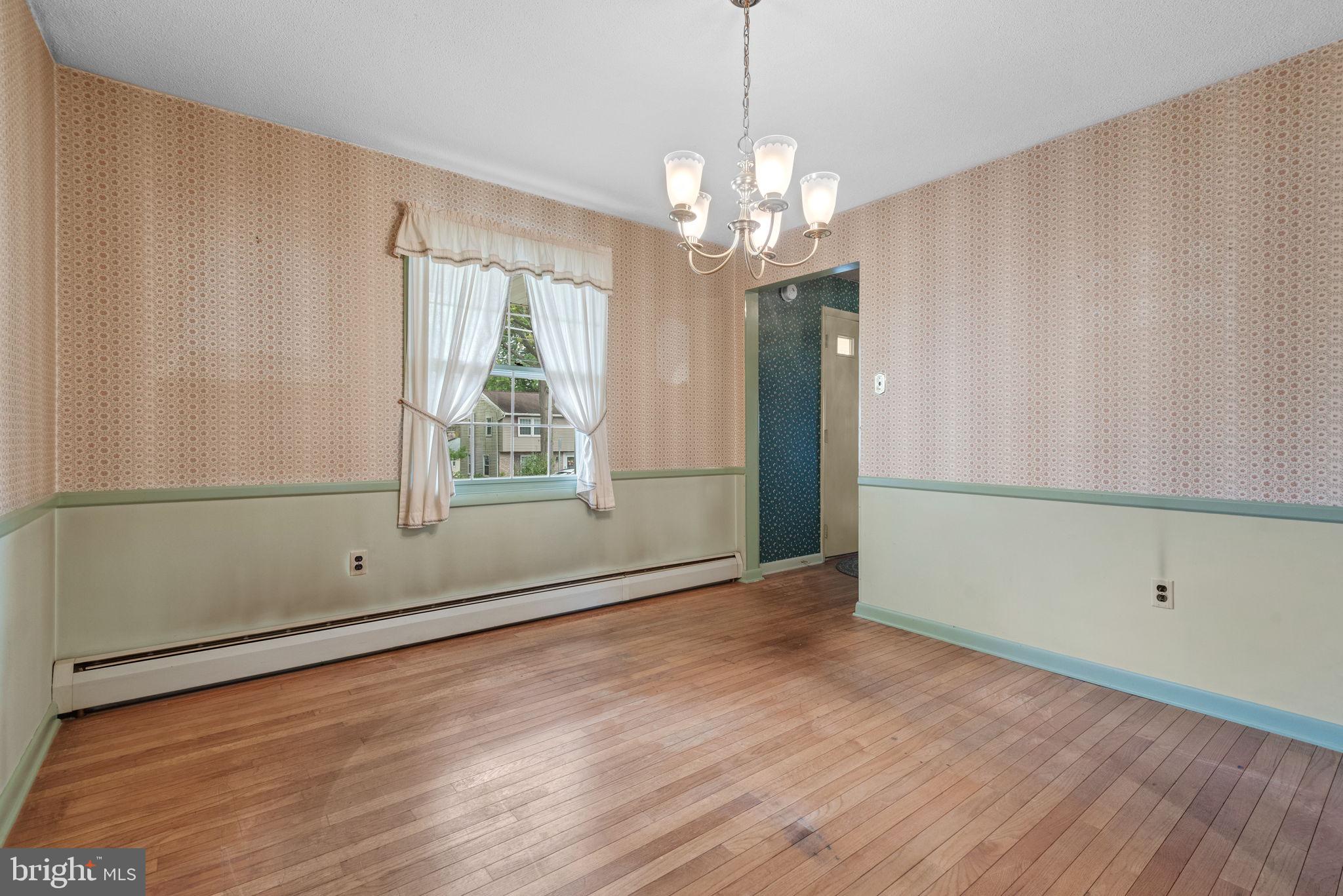 1818 Roxboro Road York, PA 17402 - Photo 11 of 39 a view of an empty room with wooden floor and a window