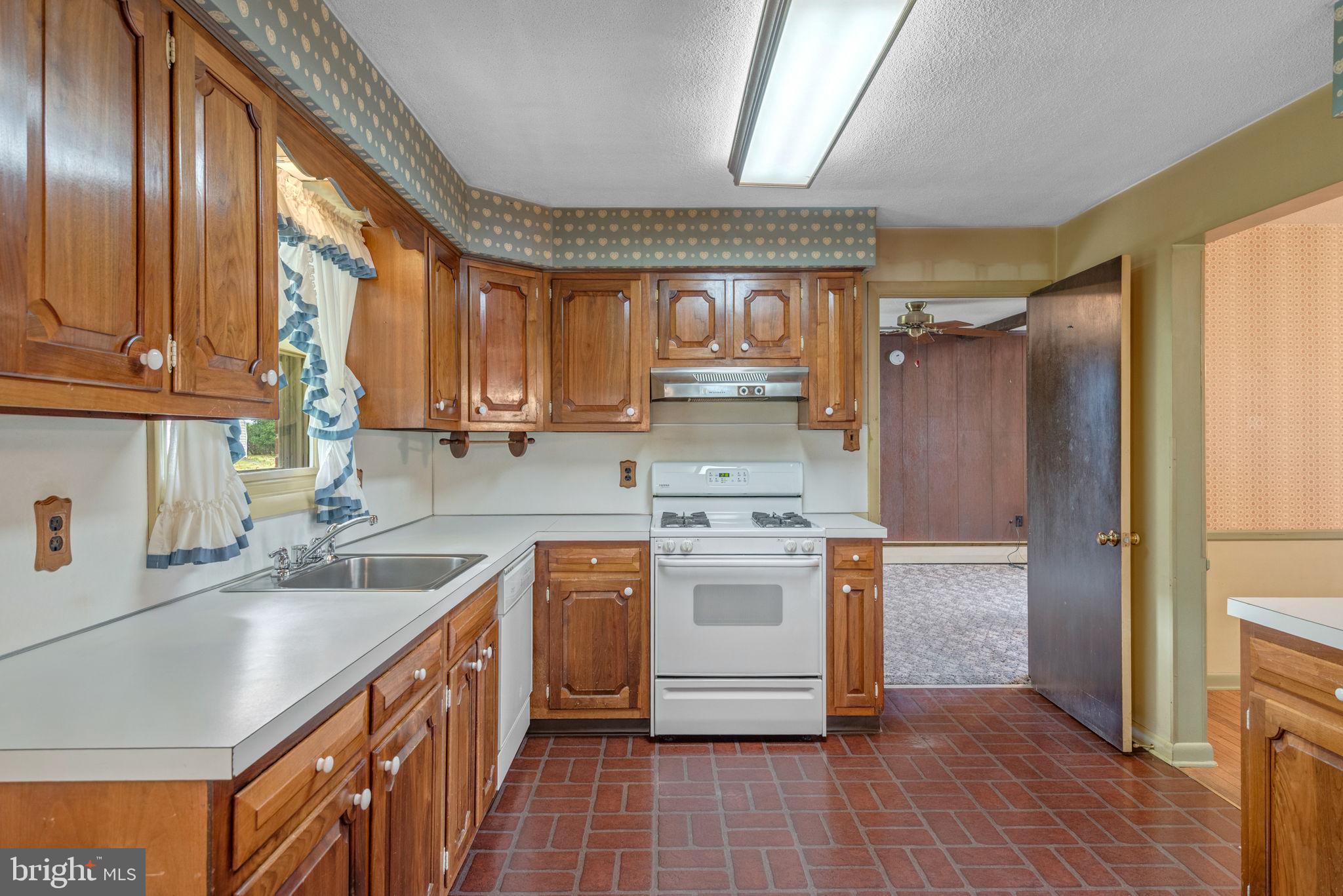 1818 Roxboro Road York, PA 17402 - Photo 14 of 39 a kitchen with stainless steel appliances granite countertop a sink stove and refrigerator