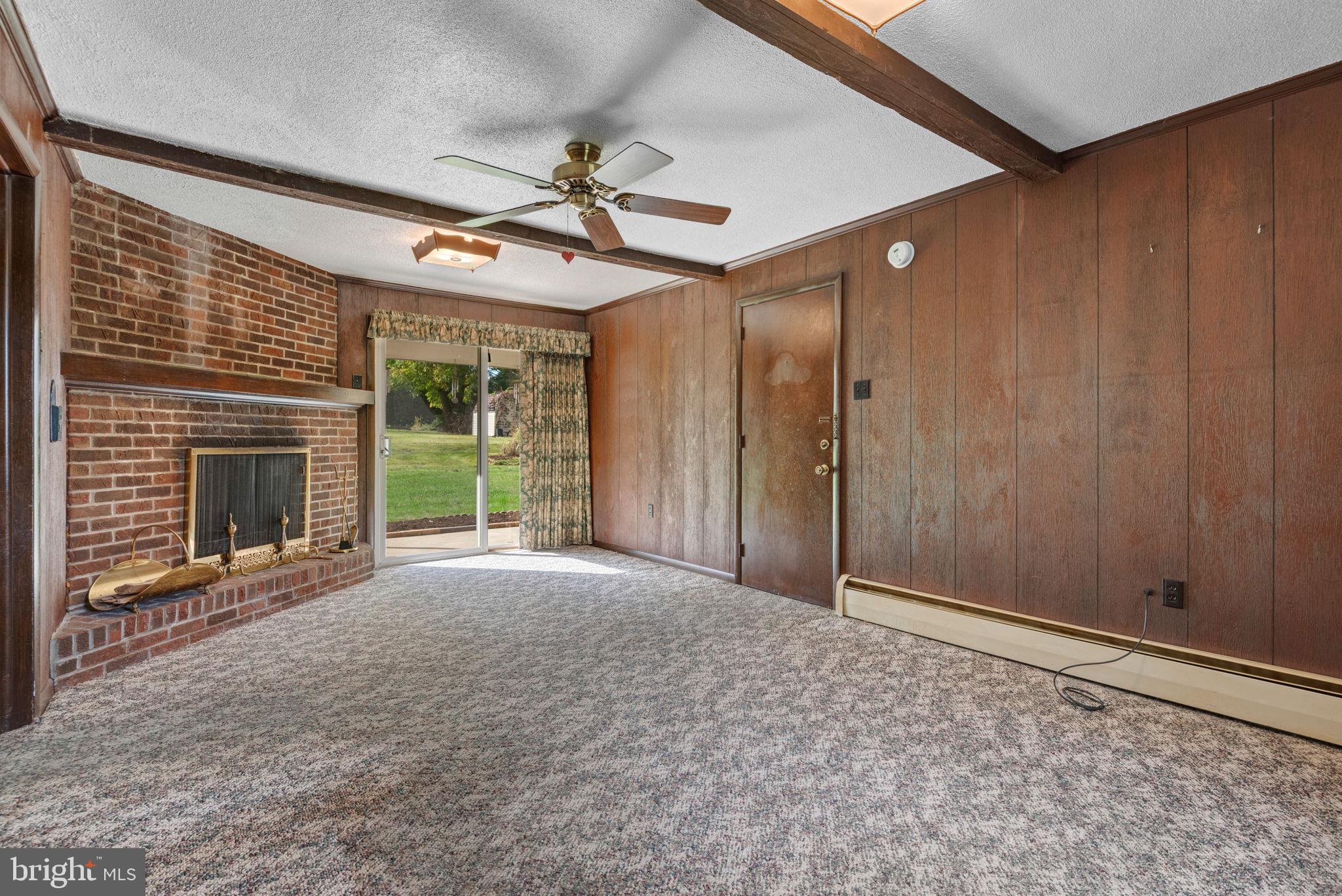 1818 Roxboro Road York, PA 17402 - Photo 17 of 39 a view of a livingroom with a fireplace and a window