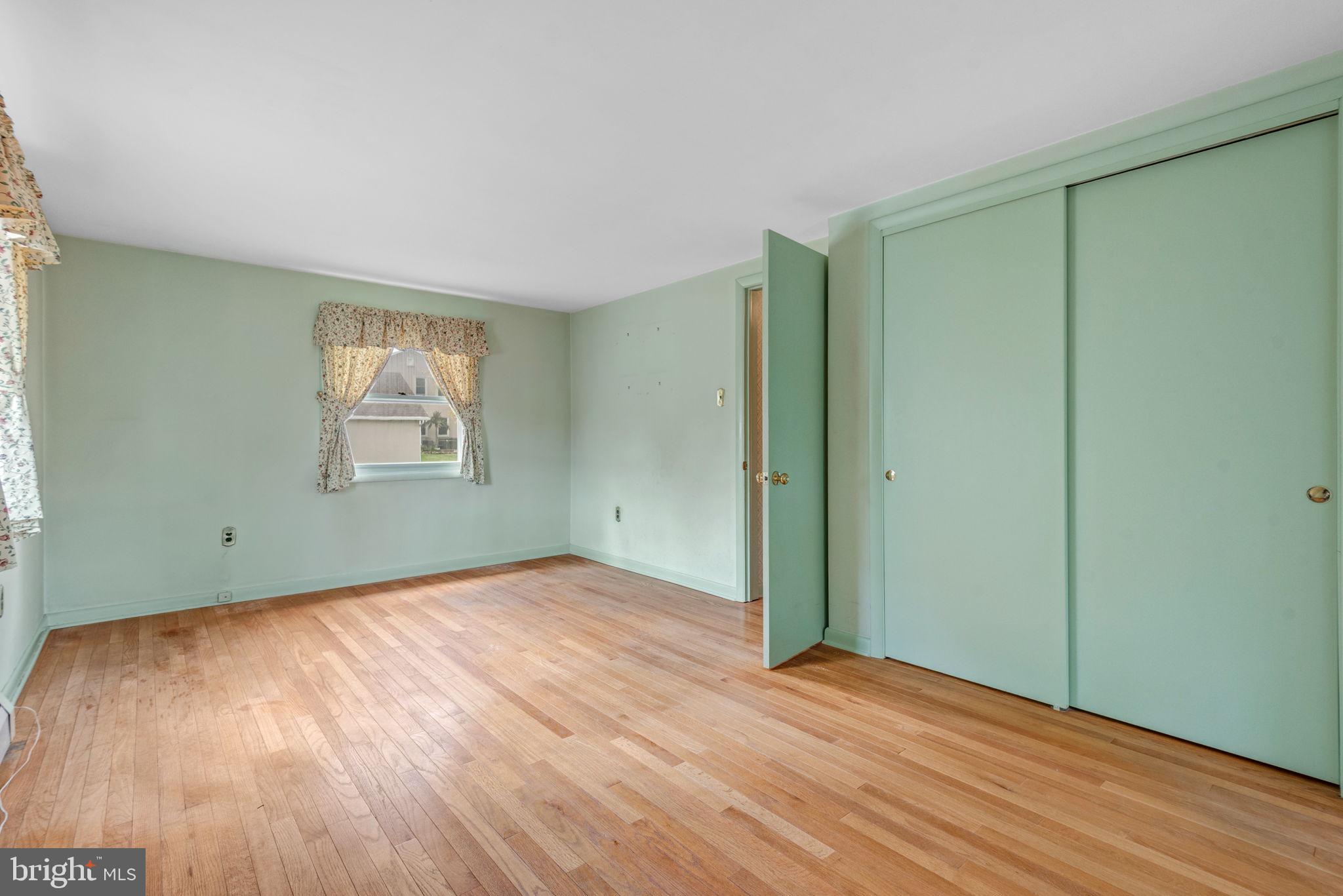 1818 Roxboro Road York, PA 17402 - Photo 23 of 39 an empty room with wooden floor closet and windows