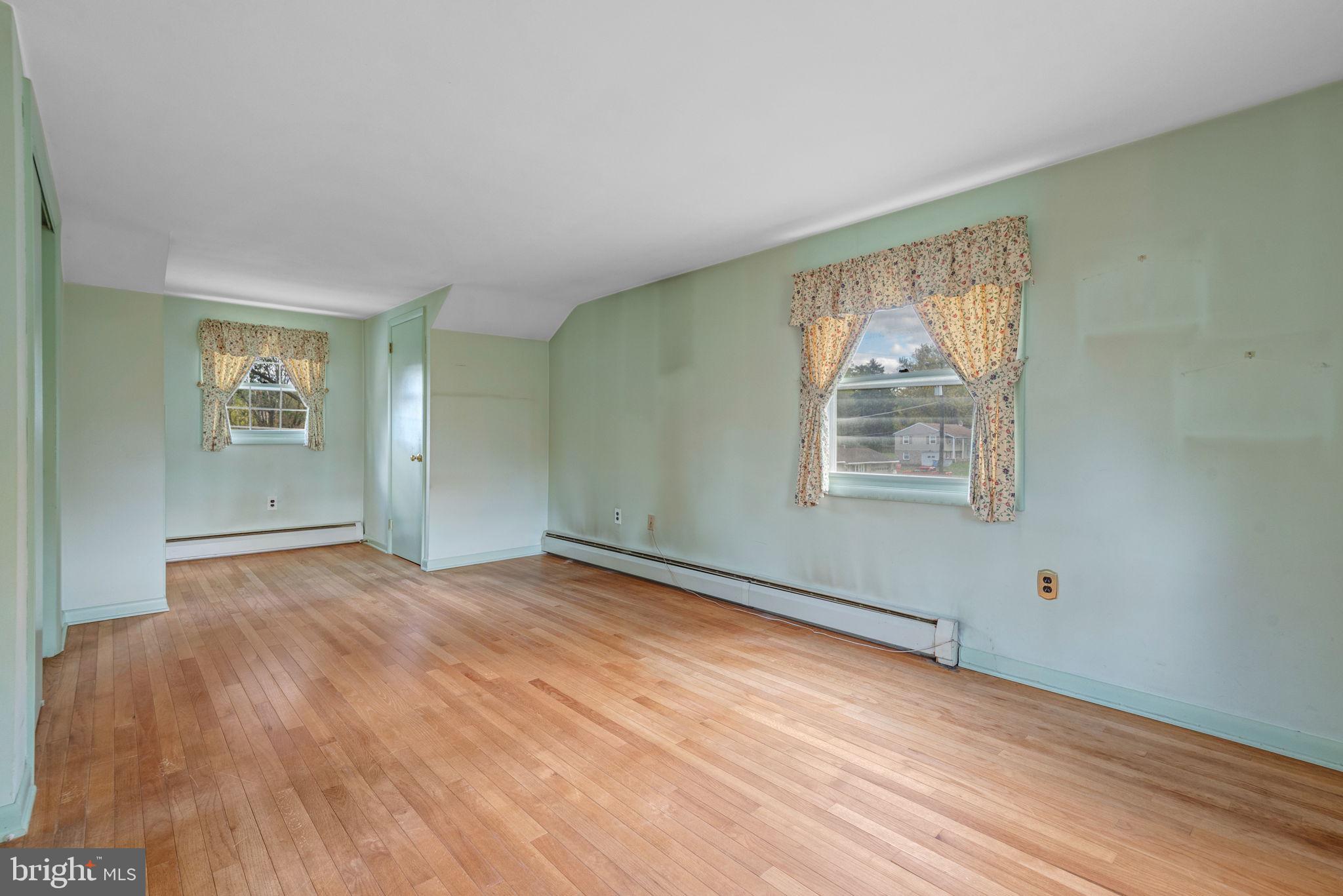 1818 Roxboro Road York, PA 17402 - Photo 24 of 39 a view of an empty room with wooden floor and a window