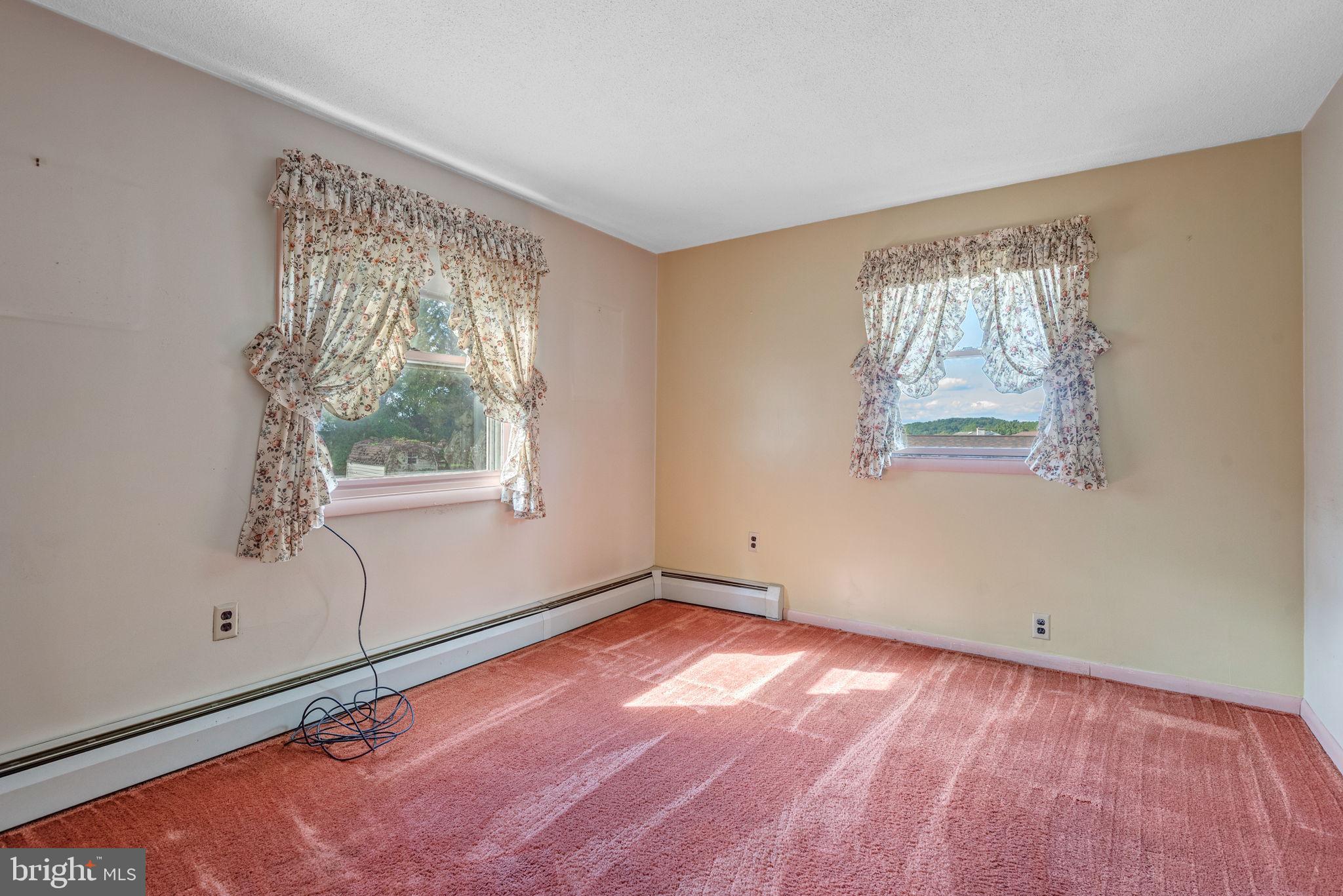 1818 Roxboro Road York, PA 17402 - Photo 28 of 39 a view of an empty room with a window and wooden floor