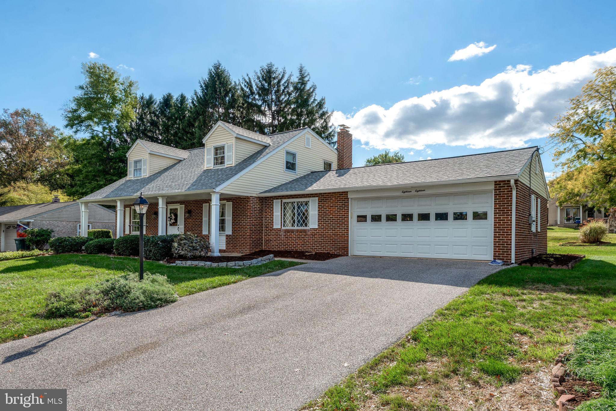 1818 Roxboro Road York, PA 17402 - Photo 32 of 39 a front view of a house with a garden and trees