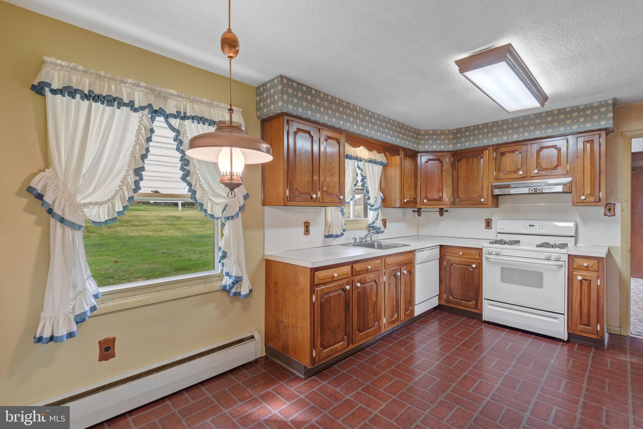 1818 Roxboro Road York, PA 17402 - Photo 5 of 39 a kitchen with a sink window and cabinets