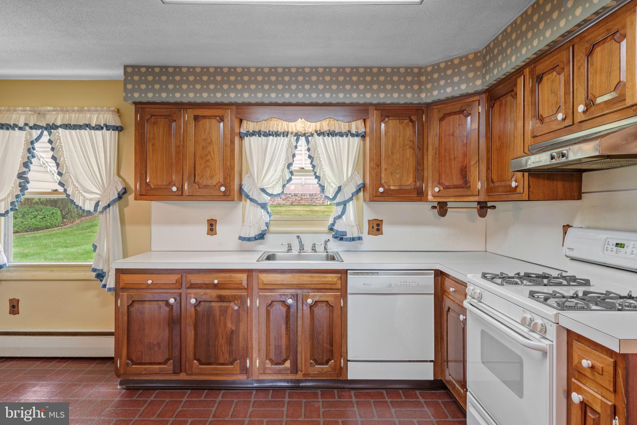 1818 Roxboro Road York, PA 17402 - Photo 6 of 39 a kitchen with a stove a sink and a microwave
