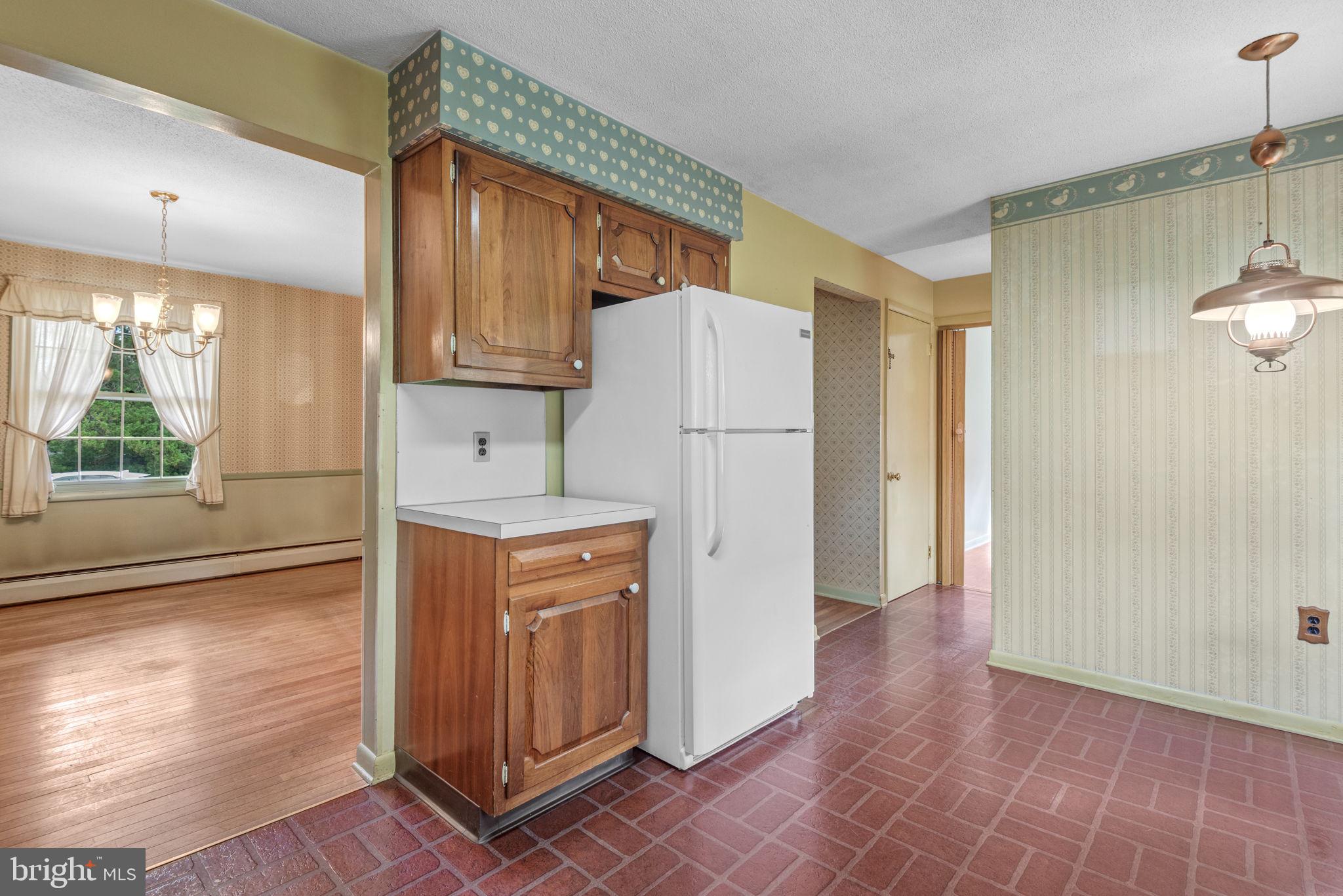 1818 Roxboro Road York, PA 17402 - Photo 7 of 39 a kitchen with refrigerator and wooden floor