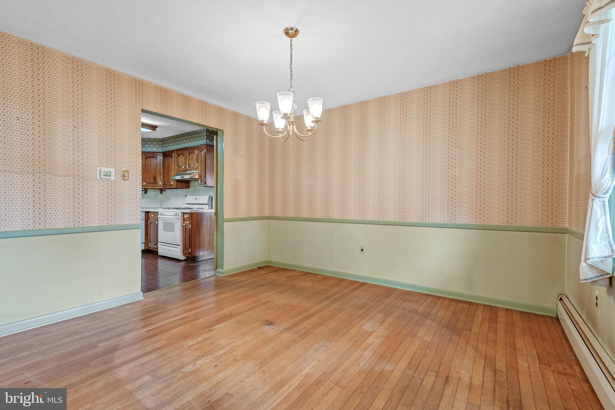 1818 Roxboro Road York, PA 17402 - Photo 10 of 39 wooden floor in an empty room with a window