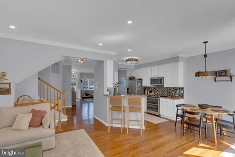 a living room with furniture a fireplace and a large window