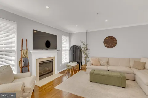 a living room with furniture a fireplace and a large window