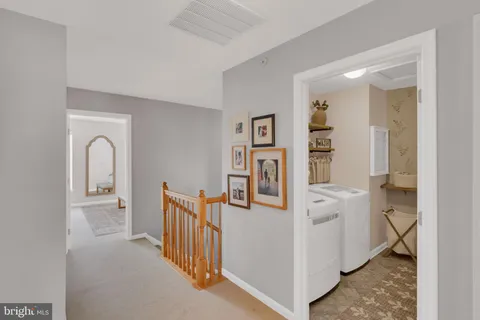 a view of a hallway with a livingroom and entryway