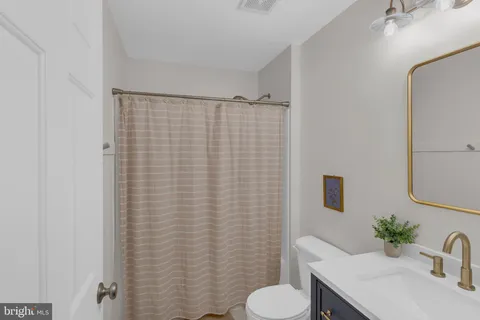 a bedroom with furniture and a flat screen tv